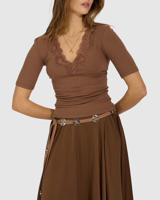 Brown Dusk to Dawn Belt with vintage-inspired concho-style hardware and decorative tassel ends with metal bead accents