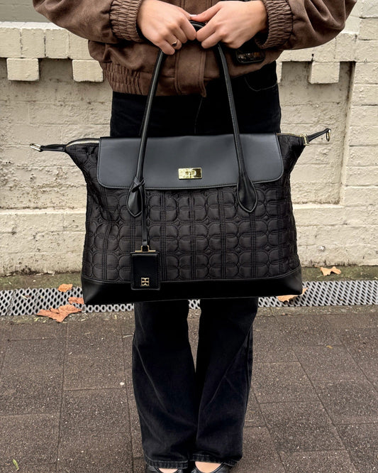 Black Just Add Sugar Quilted Bag with adjustable straps and top handle - front view